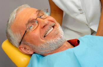 An old man treating his teeth