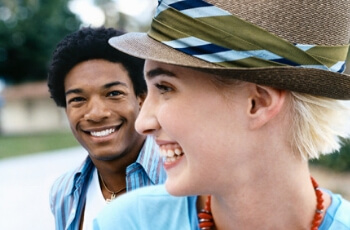 A Boy looking at a Smiling Girl