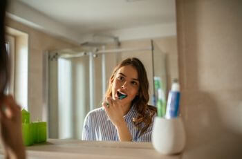 Woman brushing teeth