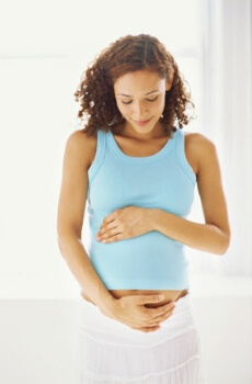 Woman holding pregnant stomach