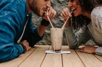 Boy and girl sharing a drink